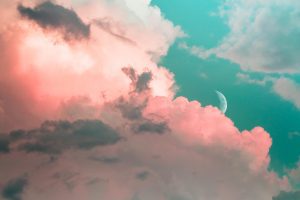 Pink and blue image of clouds and moon