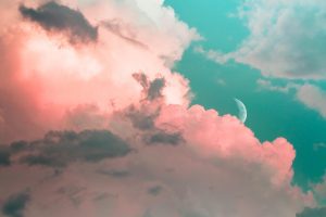 Pink and blue image of clouds and moon